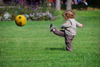 a baby playing football